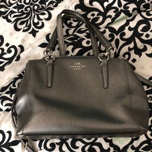 A mini 3 pocket coach purse